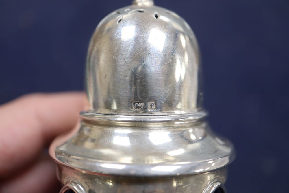 An Edwardian Arts and Crafts silver and gem set mounted blue glass sugar shaker, no makers mark, 12.3cm.